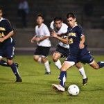 SCOTT ROEDER | Staff PhotographerFreshman midfielder Jonathan Prieto takes a shot upfield while junior defender Jorge Reyes lends support.