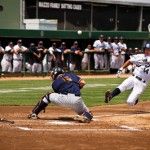 scott roeder | Staff Photographer Jeff Cusick slides into home plate safely as the ball bounces off Fullerton catcher Billy Marcoe’s shoulder.