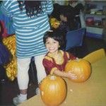 Four-year-old Rashmi proudly holds her carved Halloween pumpkin, not knowing that her name would be the cause of confusion and laughs.